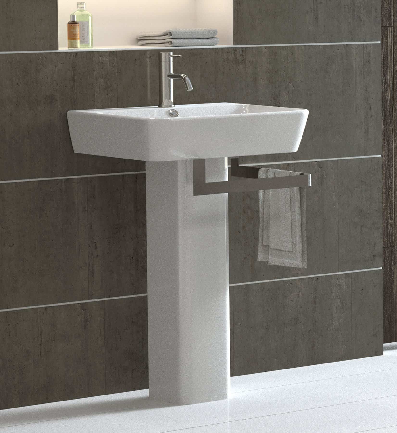 White rectangular pedestal sink with a chrome faucet against a tiled bathroom wall